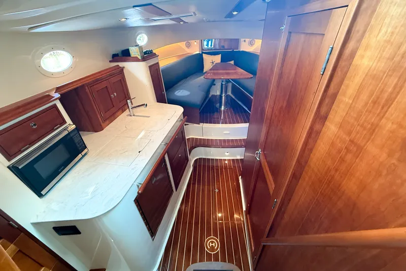 Slide: The Image of Luxurious interior of 2021 Hinckley Sport Boats 40x, featuring elegant wood finishes and modern amenities. - 17