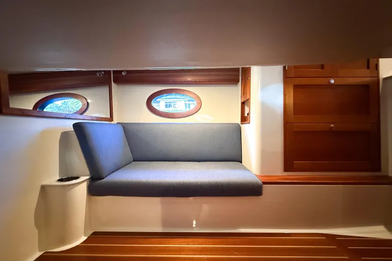 Slide: The Image of Interior of 2021 Hinckley Sport Boats 40x with elegant seating and wooden flooring. - 19