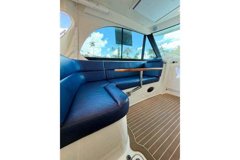 Slide: The Image of 2021 Hinckley Sport Boats 40x interior with blue seating and wooden flooring. - 24