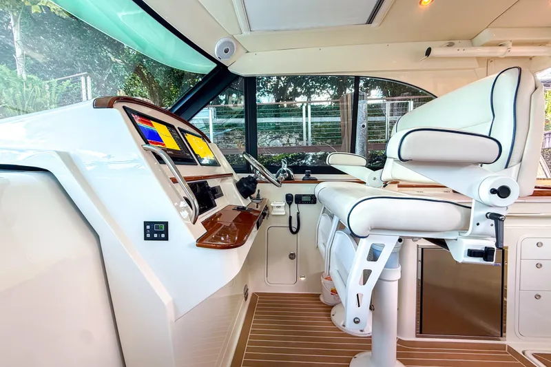 Slide: The Image of Interior of 2021 Hinckley Sport Boats 40x with blue seating and wooden flooring. - 25