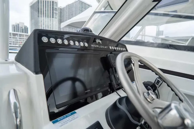 Slide: The Image of Manufacturer Provided Image: Helm of 2026 World Cat 280 DC-X boat with modern controls and cityscape background. - 10