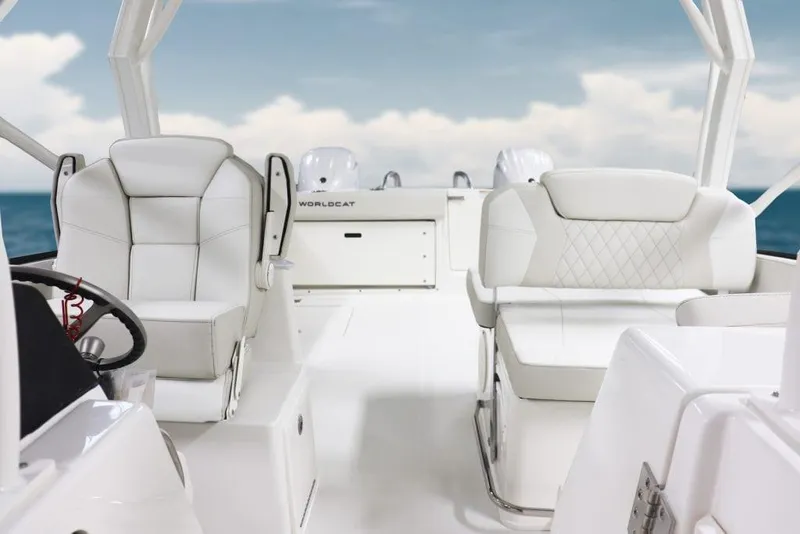 Slide: The Image of Manufacturer Provided Image: 2026 World Cat 280 DC-X boat interior with white seating and ocean backdrop. - 9