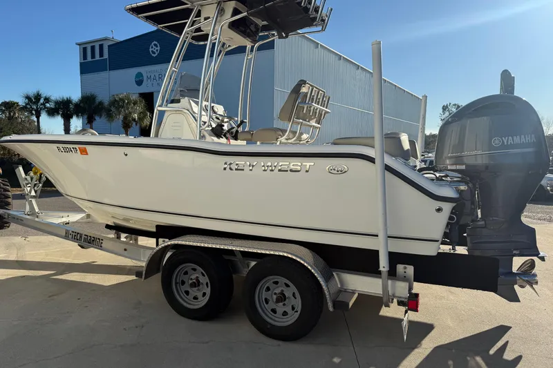 Slide: The Image of 2023 Key West 203 FS boat on trailer with Yamaha engine, parked outdoors. - 3