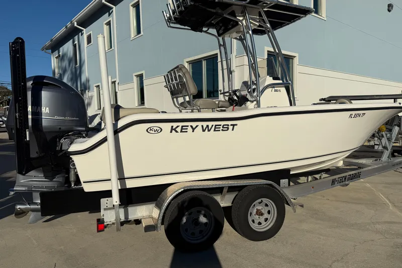 Slide: The Image of 2023 Key West 203 FS boat on trailer, parked near a building. - 4