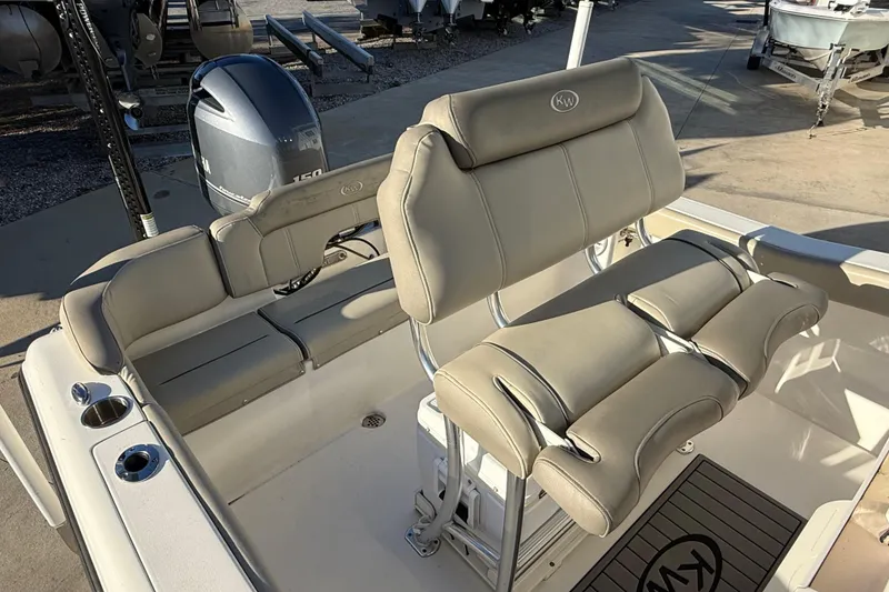 Slide: The Image of 2023 Key West 203 FS boat interior with cushioned seating and outboard motor. - 9
