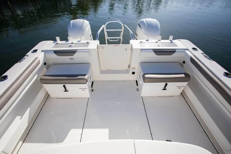 Slide: The Image of 2026 World Cat 325 CC boat dashboard with navigation screens and steering wheel. - 15