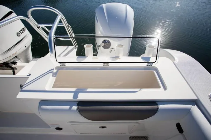 Slide: The Image of Interior of 2026 World Cat 325 CC boat featuring a compact marine toilet. - 16