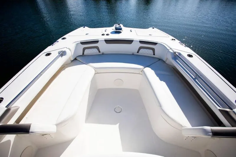 Slide: The Image of 2026 World Cat 325 CC boat interior with dual Mercury engines on a calm waterway. - 9