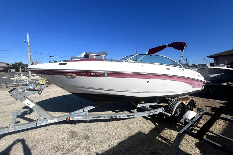 The Image of 2002 Chaparral 216 SSi boat on trailer under clear blue sky. - 0
