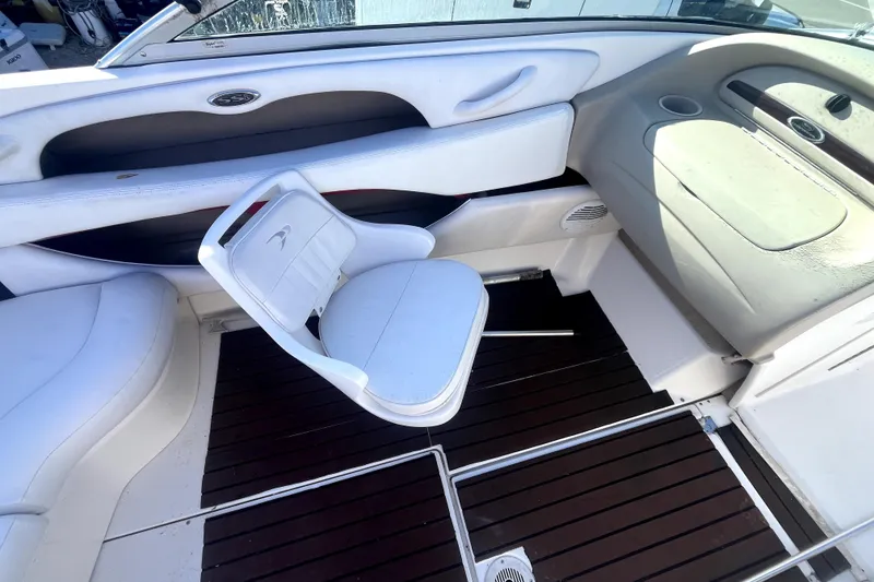 Slide: The Image of Interior of a 2002 Chaparral 216 SSi boat with white seating and wood flooring. - 10