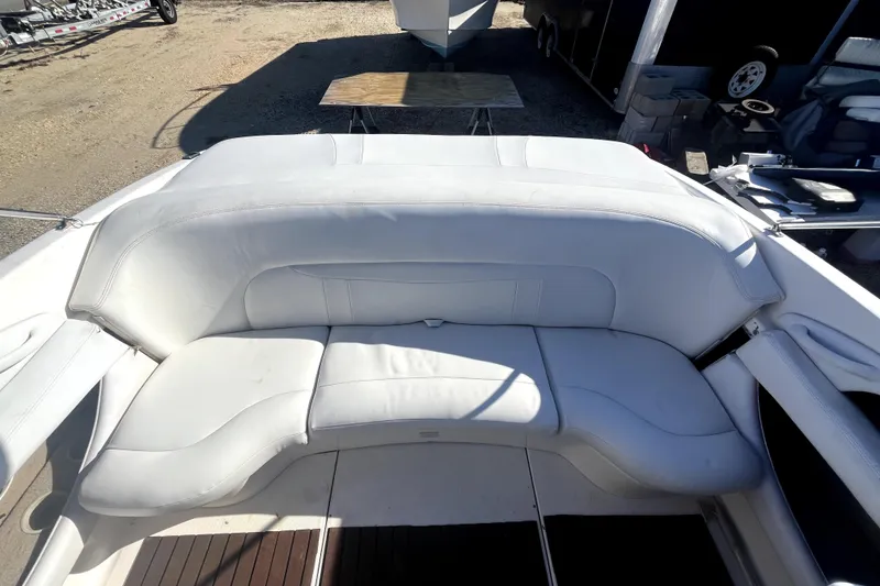 Slide: The Image of White leather seating on a 2002 Chaparral 216 SSi boat, outdoor setting. - 11