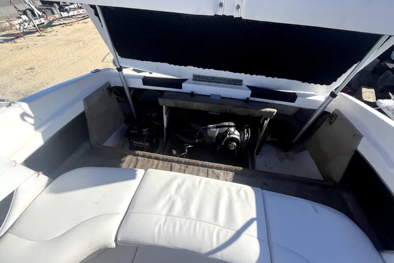Slide: The Image of 2002 Chaparral 216 SSi boat engine compartment with open hatch and visible seating. - 14