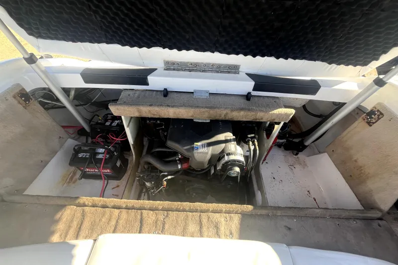 Slide: The Image of Engine compartment of a 2002 Chaparral 216 SSi boat, showing batteries and engine components. - 15