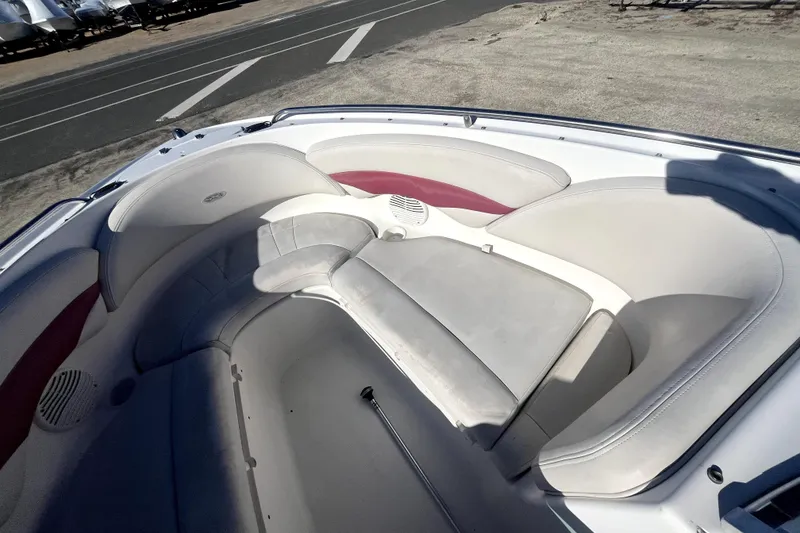Slide: The Image of 2002 Chaparral 216 SSi boat interior with white and red cushioned seating. - 3