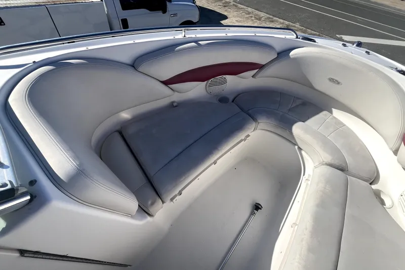 Slide: The Image of Interior seating of a 2002 Chaparral 216 SSi boat, featuring white and red upholstery. - 4