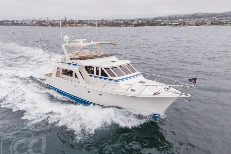 The Image of 1999 Offshore Yachts 52 Pilothouse cruising on open water, showcasing sleek design and elegance. - 0