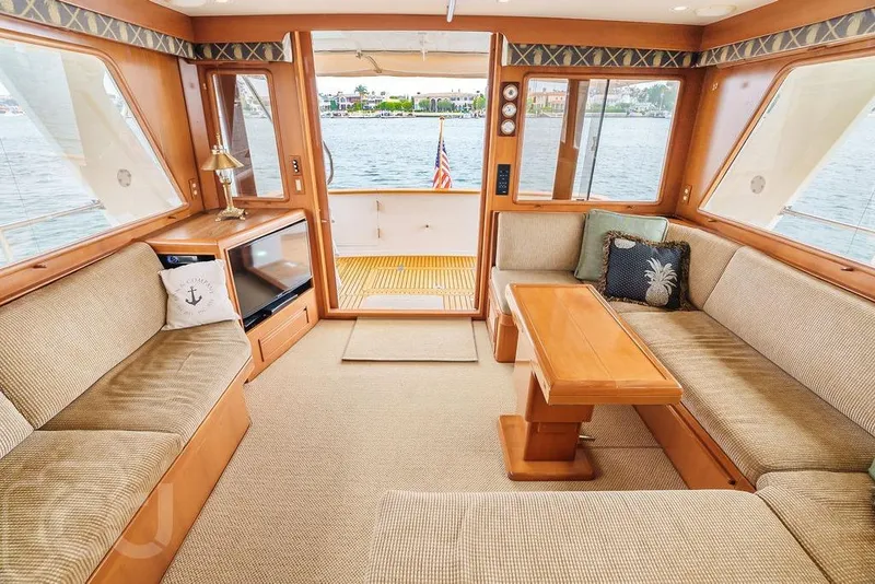 Slide: The Image of Luxurious interior of 1999 Offshore Yachts 52 Pilothouse with elegant seating and wooden accents. - 11