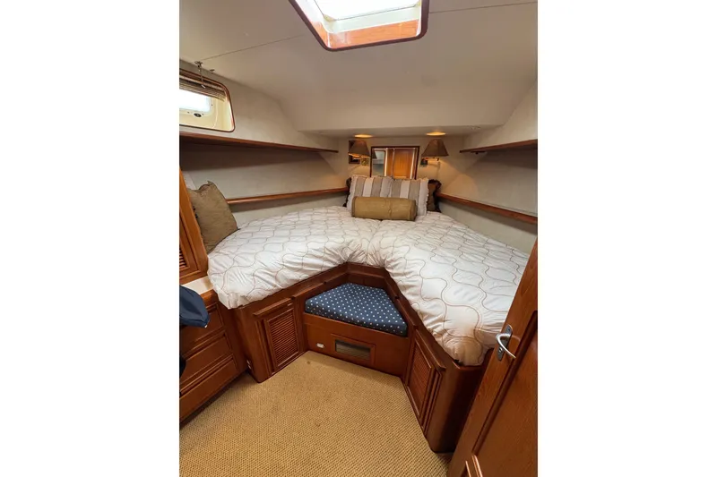 Slide: The Image of Cozy cabin interior of 1999 Offshore Yachts 52 Pilothouse with elegant bedding and wood accents. - 16