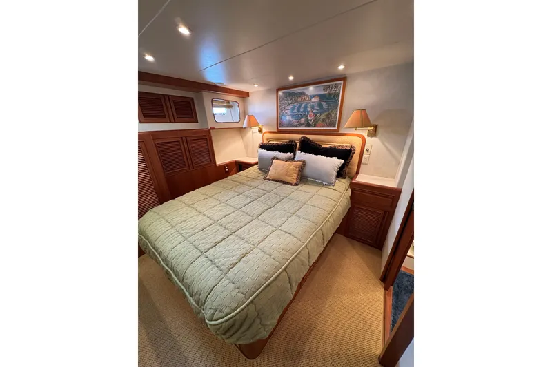 Slide: The Image of Luxurious bedroom interior of 1999 Offshore Yachts 52 Pilothouse with elegant bedding and decor. - 18