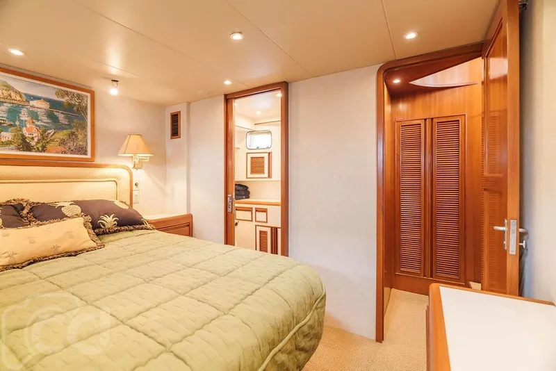Slide: The Image of Luxurious bedroom interior of 1999 Offshore Yachts 52 Pilothouse with elegant wood finishes. - 20