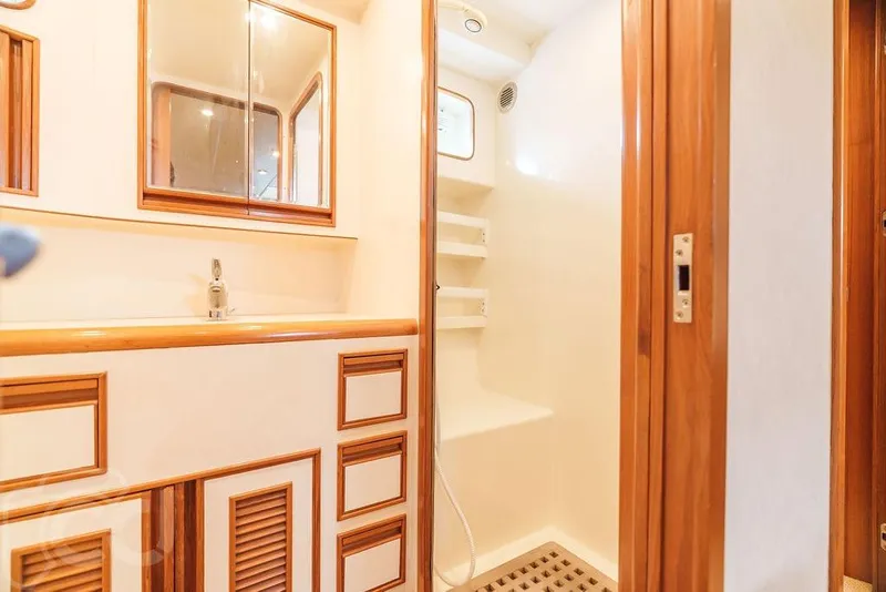 Slide: The Image of Luxurious bathroom in 1999 Offshore Yachts 52 Pilothouse, featuring wood accents and modern fixtures. - 21