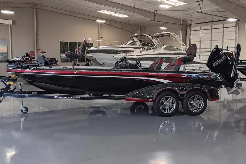 Slide: The Image of 2025 Ranger Z520 bass boat in showroom, sleek design, black and red accents. - 0