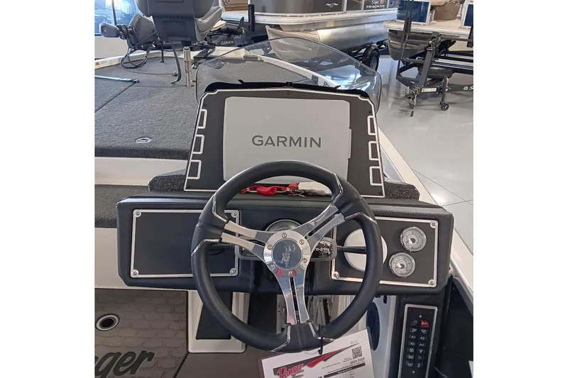 Slide: The Image of 2025 Ranger Z520 boat dashboard with Garmin navigation system and steering wheel. - 15