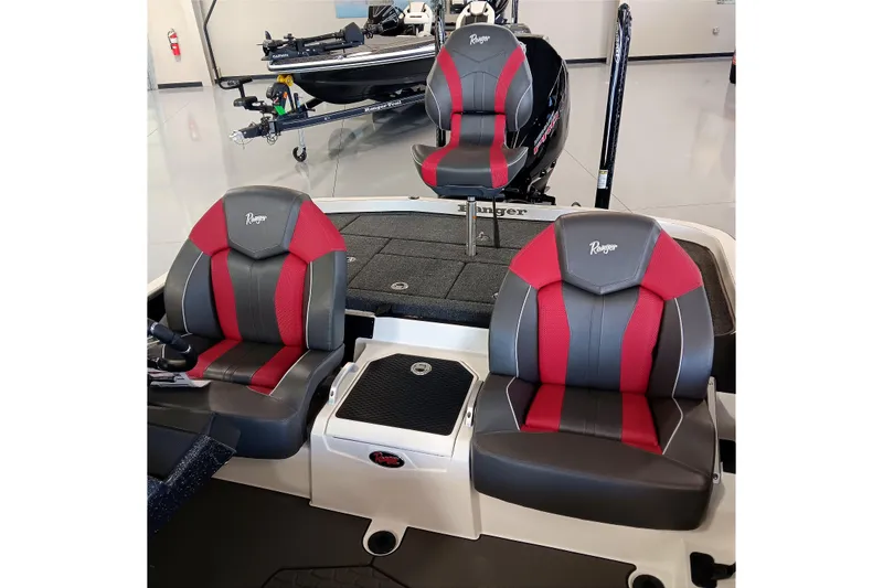 Slide: The Image of 2025 Ranger Z520 boat interior with red and gray seats in showroom. - 16
