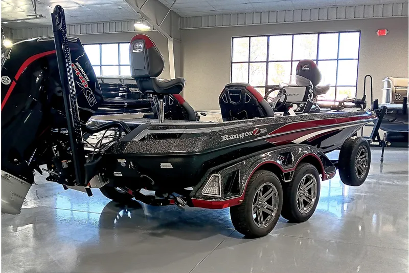 Slide: The Image of 2025 Ranger Z520 boat in showroom, featuring sleek design and dual-axle trailer. - 6