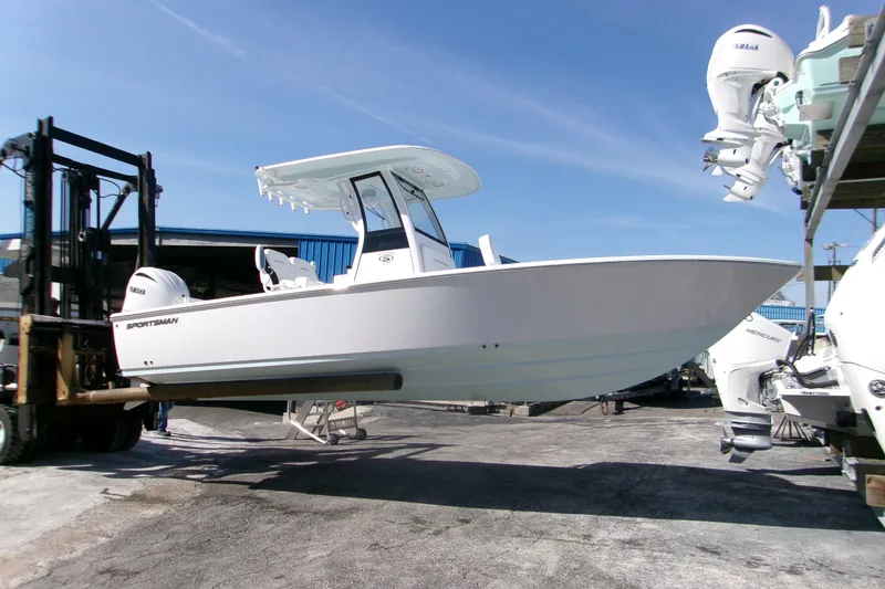 The Image of 2026 Sportsman Masters 247 Bay Boat on forklift, showcasing sleek design and Yamaha engines. - 0