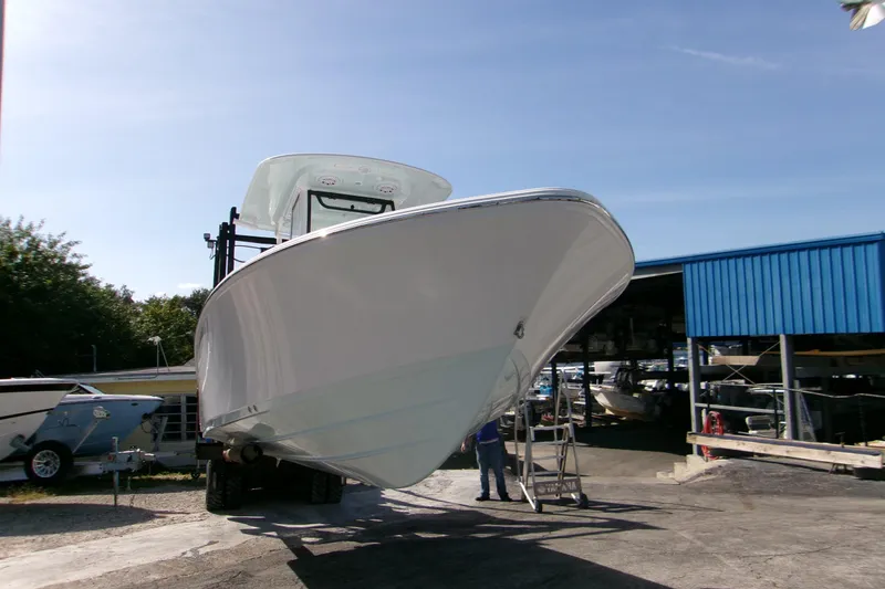 Slide: The Image of 2026 Sportsman Masters 247 Bay Boat on trailer at marina, clear sky background. - 1