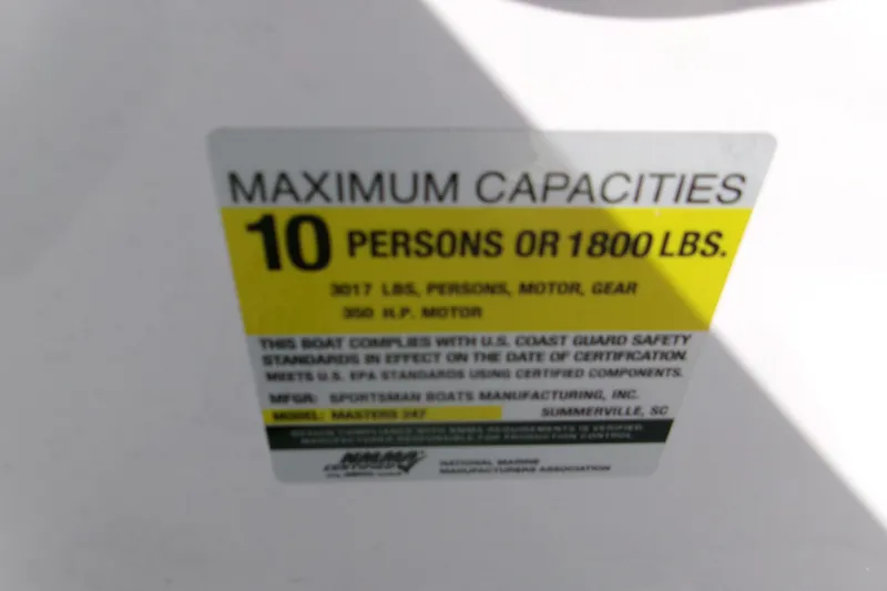 Slide: The Image of 2026 Sportsman Masters 247 Bay Boat capacity label: 10 persons or 1800 lbs, 250 HP motor. - 13