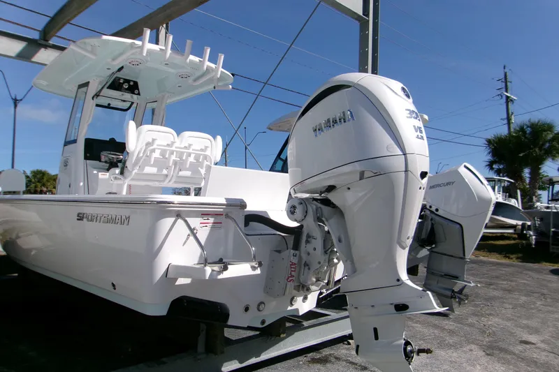 Slide: The Image of 2026 Sportsman Masters 247 Bay Boat with Yamaha outboard engine, parked outdoors. - 16