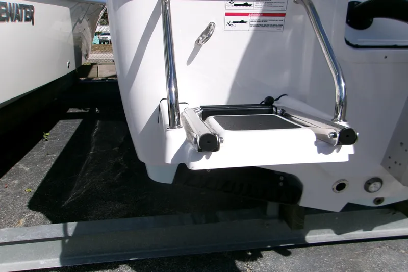 Slide: The Image of 2026 Sportsman Masters 247 Bay Boat with foldable swim ladder and stainless steel rails. - 2