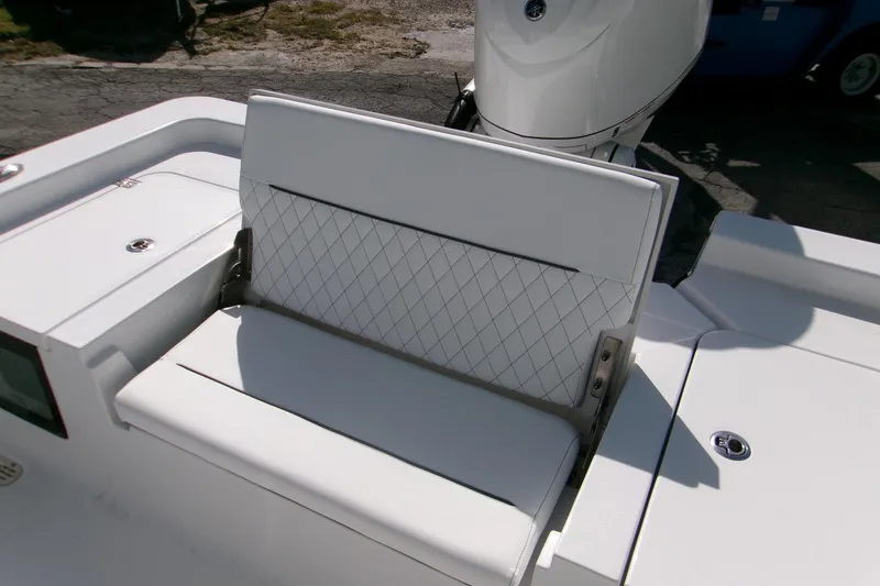 Slide: The Image of 2026 Sportsman Masters 247 Bay Boat with white cushioned seating and diamond pattern design. - 4