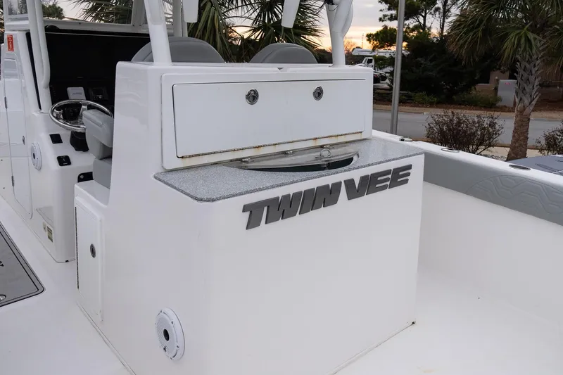 Slide: The Image of 2023 Twin Vee 280 GFX CC boat interior with console and seating area. - 11
