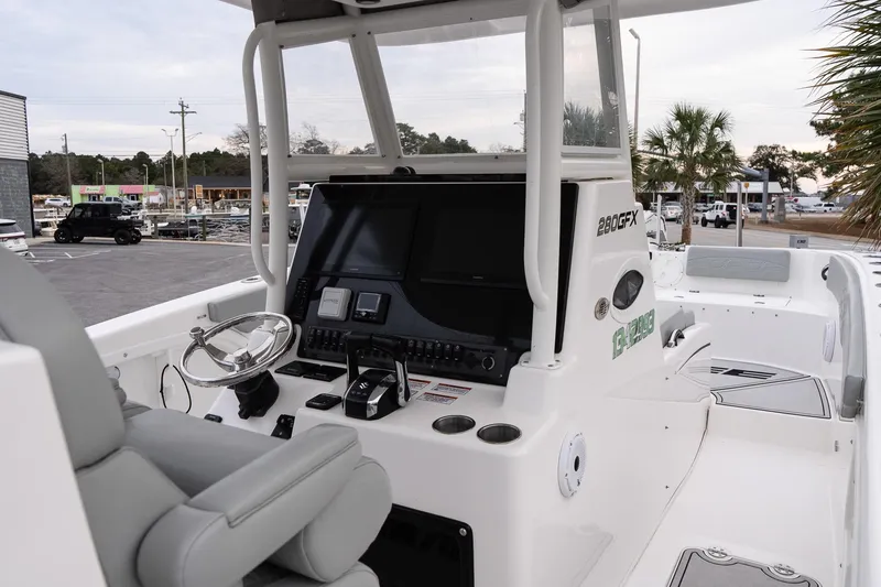 Slide: The Image of 2023 Twin Vee 280 GFX CC boat interior with modern helm and seating. - 13