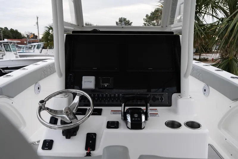 Slide: The Image of 2023 Twin Vee 280 GFX CC boat helm with steering wheel and control panel. - 14
