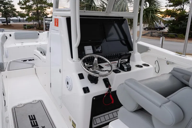 Slide: The Image of 2023 Twin Vee 280 GFX CC boat interior with modern helm and seating. - 15