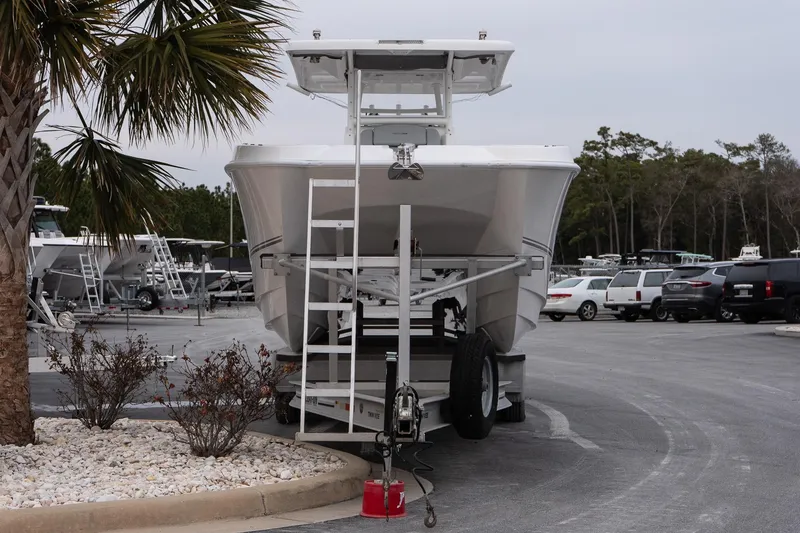 Slide: The Image of 2023 Twin Vee 280 GFX CC boat on trailer in parking lot with palm tree. - 3