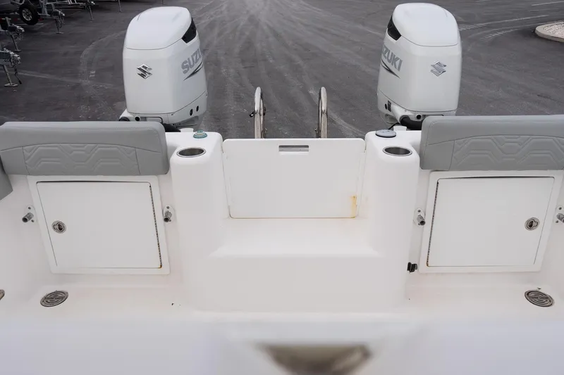 Slide: The Image of 2023 Twin Vee 280 GFX CC boat with dual Suzuki outboard engines, rear view. - 8