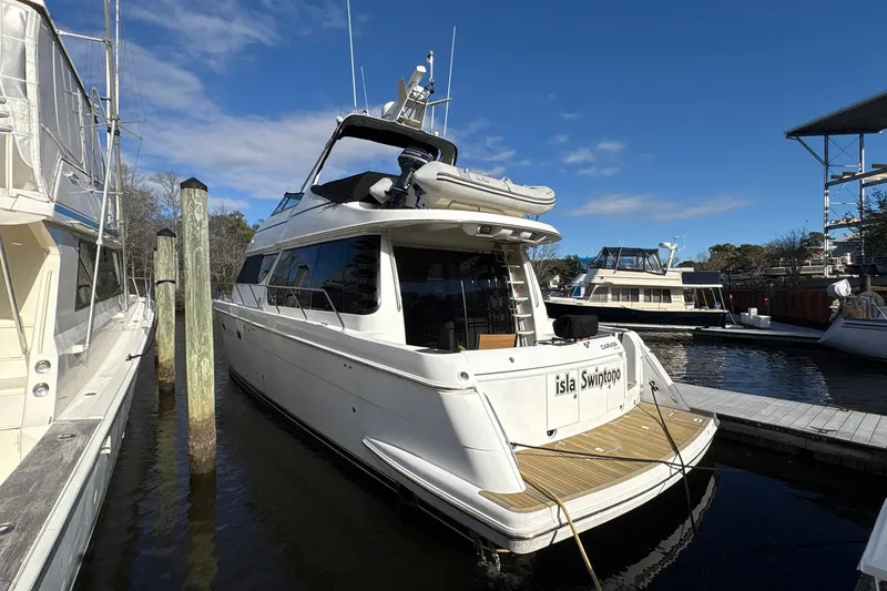 Slide: The Image of 1999 Carver 530 Voyager Pilothouse yacht docked at marina under clear blue sky. - 10