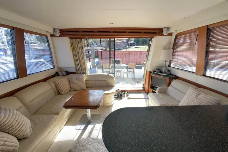 Slide: The Image of Luxurious interior of 1999 Carver 530 Voyager Pilothouse yacht with elegant seating and table. - 22