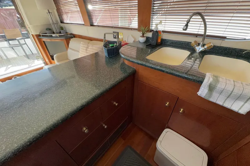 Slide: The Image of Interior of 1999 Carver 530 Voyager Pilothouse kitchen with sink and countertop. - 26