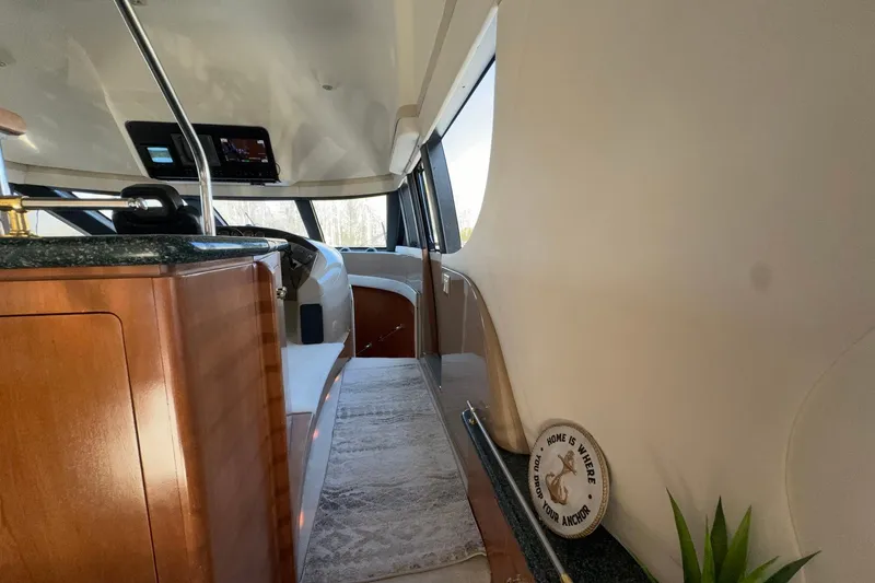 Slide: The Image of Interior of 1999 Carver 530 Voyager Pilothouse with wood accents and modern controls. - 30