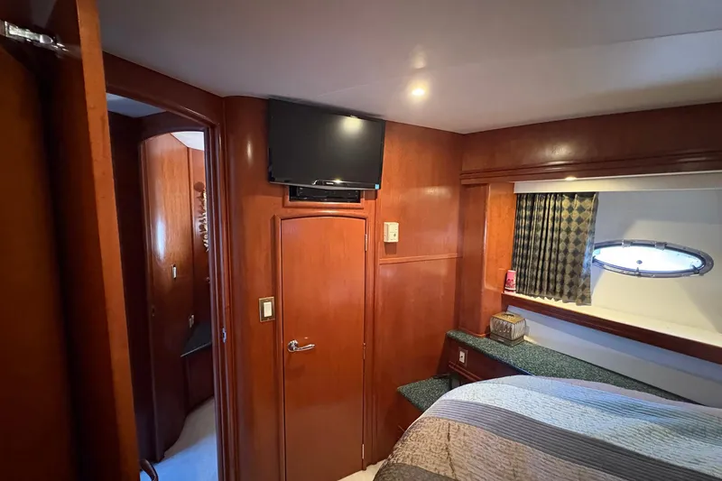 Slide: The Image of Interior of 1999 Carver 530 Voyager Pilothouse with wood paneling and a small window. - 47