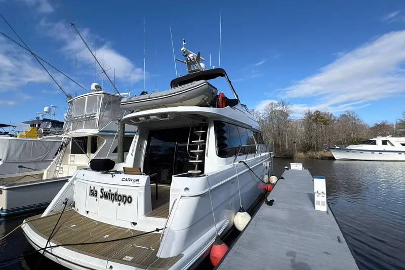 Slide: The Image of 1999 Carver 530 Voyager Pilothouse yacht docked on a sunny day. - 5