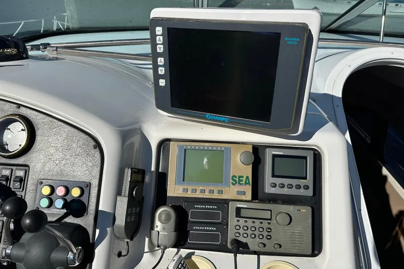 Slide: The Image of Control panel of a 1999 Carver 530 Voyager Pilothouse with navigation equipment. - 53