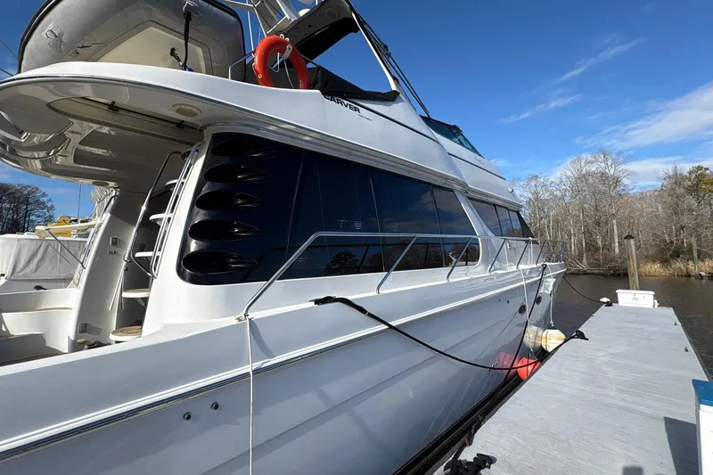 Slide: The Image of 1999 Carver 530 Voyager Pilothouse yacht docked on a sunny day. - 6
