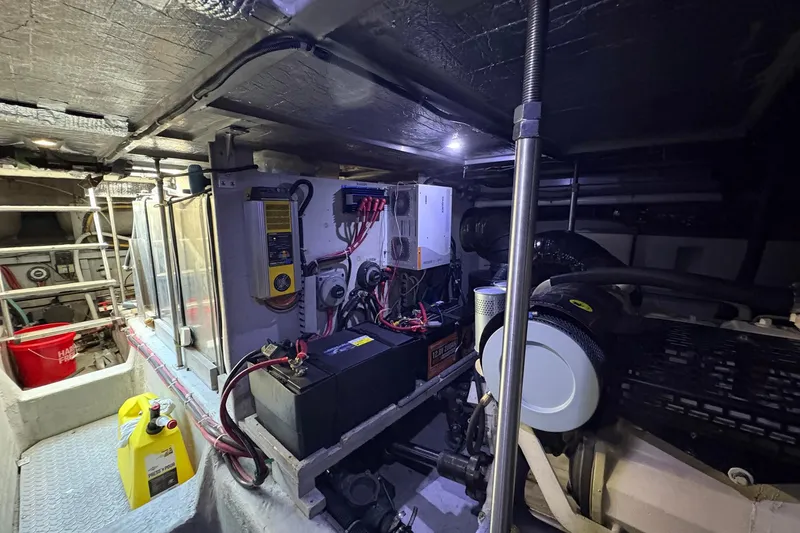Slide: The Image of Engine room of 1999 Carver 530 Voyager Pilothouse with batteries and equipment. - 61